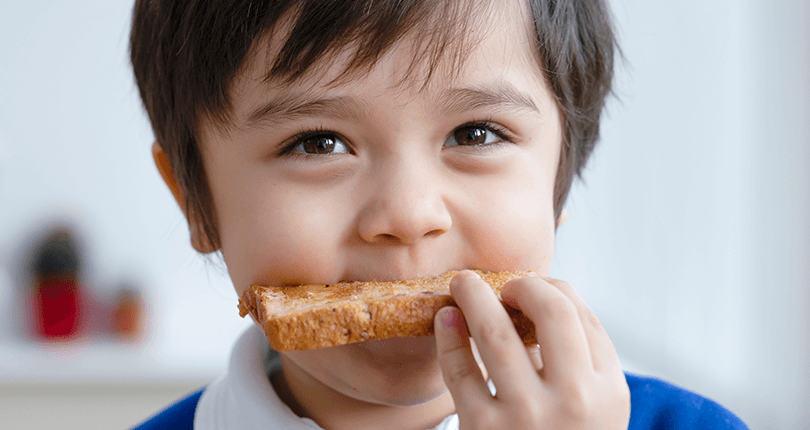 Boy eating toast 810 x 430 Blog Popup | Food for thought - planning breakfast clubs