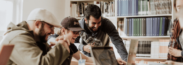 a group of happy employees laughing