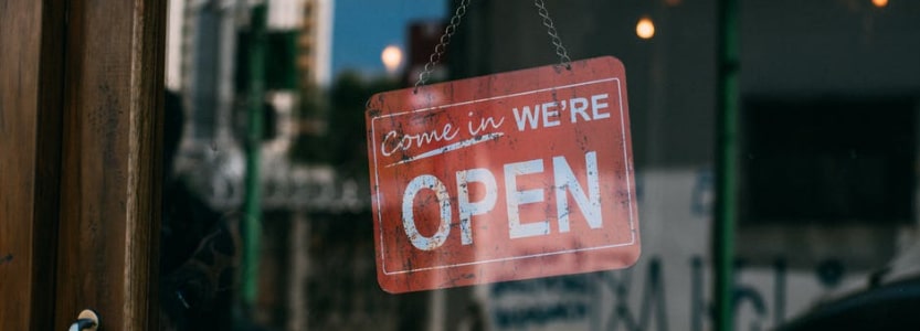 Open for business sign in shop window