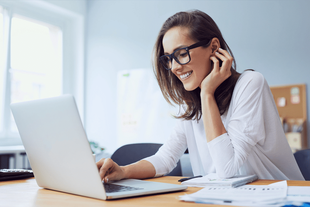 Young woman working on laptop with corporation tax software