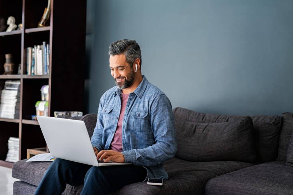 Person on laptop on sofa