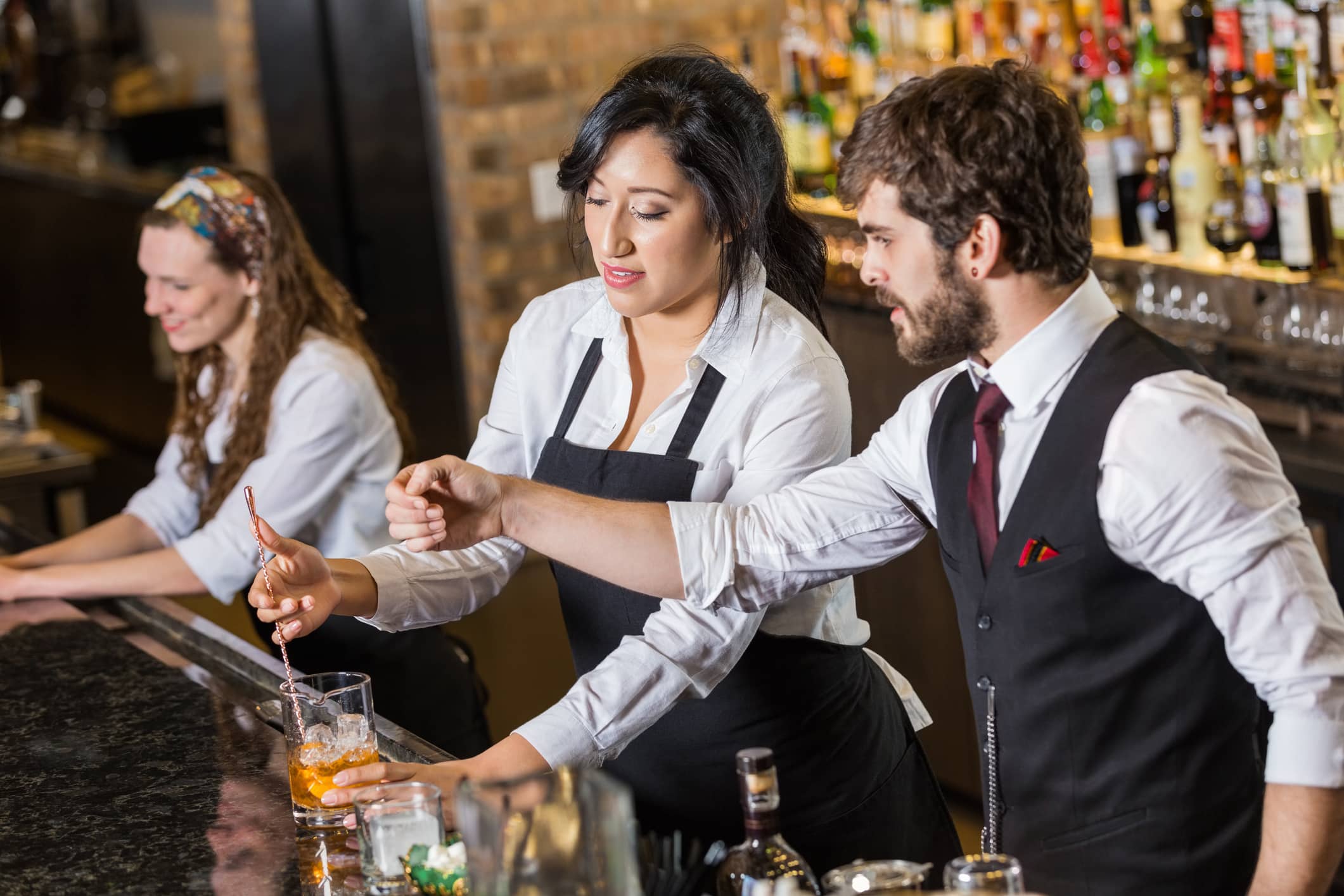 Bar staff making drinks