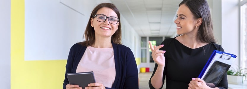 two colleagues of businesswoman walking and talking on | How to make flexible working in schools and MATs a retention-driving reality  