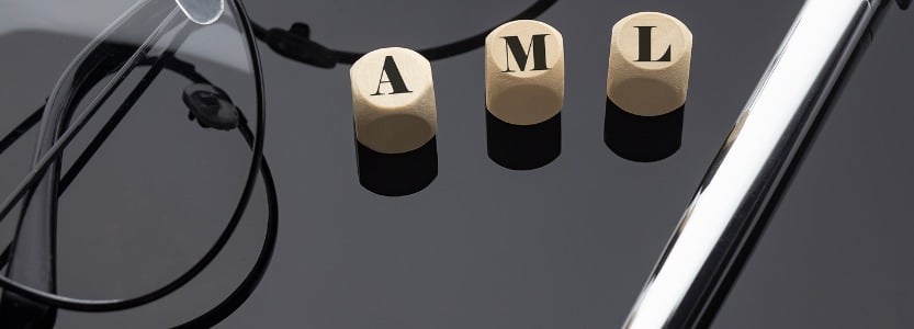 anti money laundering concept words on wooden blocks on the black background with pen | What is Anti-Money Laundering (AML) and how does it impact accountants?