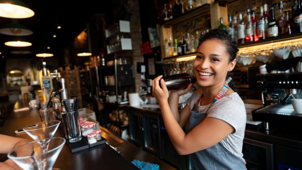 happy bartender mixing drinks at the bar.jpg s1024x1024wisk20cleUcmqJPxcXUISnedGqXbMQsz171r4eIb5W52342Xj0 | Three tips for managing rota demands in hospitality