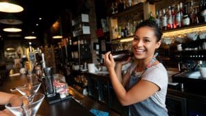 happy bartender mixing drinks at the bar.jpg s1024x1024wisk20cleUcmqJPxcXUISnedGqXbMQsz171r4eIb5W52342Xj0 | Three tips for managing rota demands in hospitality